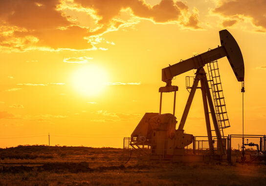 Oil pump oil rig energy industrial machine for petroleum in the sunset background